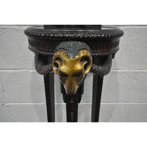 1243 - A MAHOGANY TORCHERE STAND, with three painted rams heads and central finial, on hoof style feet, dia... 