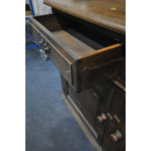 1244 - A 20TH CENTURY ELM DRESSER, the top with a two tier plate rack, base with three drawers over three c... 