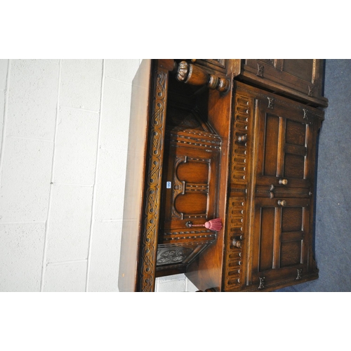 1252 - A 20TH CENTURY OAK COURT CUPBOARD, a single door above two drawers and two cupboard doors, length 12... 