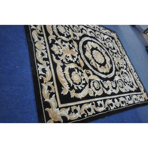 1283 - A G.H.FRITH CHINESE HANDKNOTTED BLACK GROUND RUG  with brown and beige foliate detailing and a centr... 