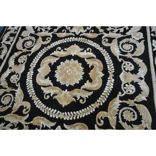 1283 - A G.H.FRITH CHINESE HANDKNOTTED BLACK GROUND RUG  with brown and beige foliate detailing and a centr... 