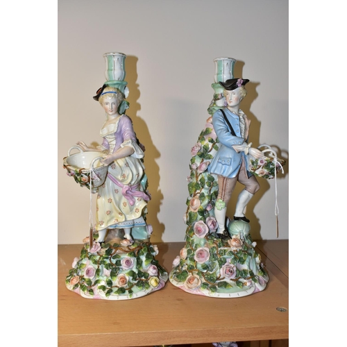 345 - A PAIR OF LATE 19TH CENTURY SITZENDORF FLORAL ENCRUSTED FIGURAL CANDLESTICKS, modelled as a male and... 