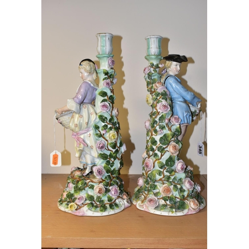 345 - A PAIR OF LATE 19TH CENTURY SITZENDORF FLORAL ENCRUSTED FIGURAL CANDLESTICKS, modelled as a male and... 