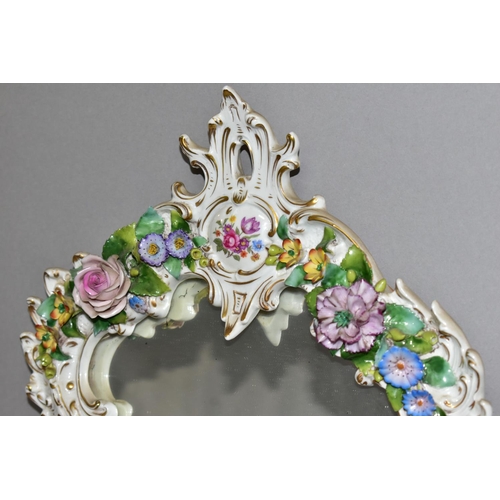 381 - A MID 20TH CENTURY CAPODIMONTE FLORAL ENCRUSTED PORCELAIN FRAMED MIRROR, Rococo style frame, the bac... 