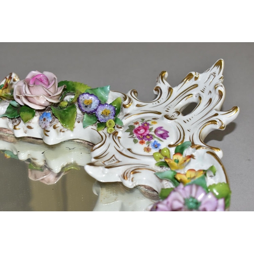 381 - A MID 20TH CENTURY CAPODIMONTE FLORAL ENCRUSTED PORCELAIN FRAMED MIRROR, Rococo style frame, the bac... 