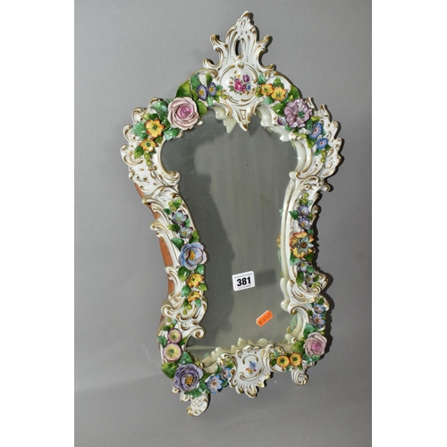 381 - A MID 20TH CENTURY CAPODIMONTE FLORAL ENCRUSTED PORCELAIN FRAMED MIRROR, Rococo style frame, the bac... 