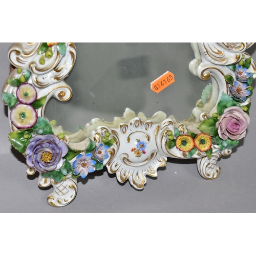 381 - A MID 20TH CENTURY CAPODIMONTE FLORAL ENCRUSTED PORCELAIN FRAMED MIRROR, Rococo style frame, the bac... 