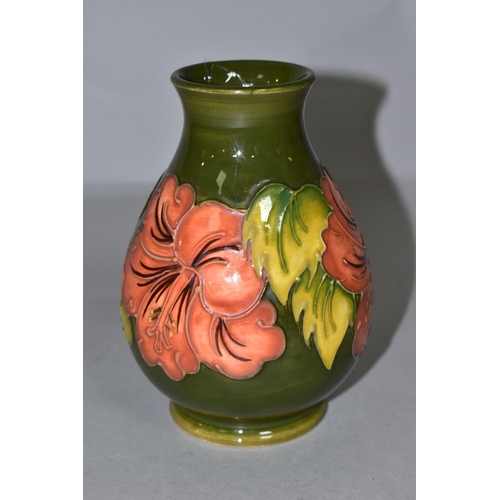 382 - A MOORCROFT POTTERY BALUSTER VASE DECORATED WITH CORAL HIBISCUS ON A GREEN GROUND, impressed marks t... 