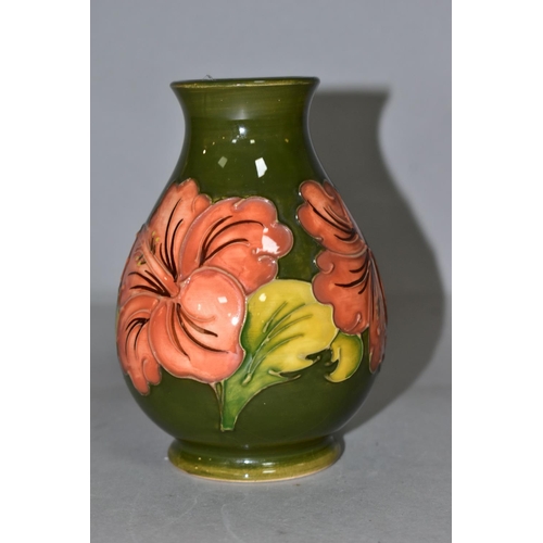 382 - A MOORCROFT POTTERY BALUSTER VASE DECORATED WITH CORAL HIBISCUS ON A GREEN GROUND, impressed marks t... 