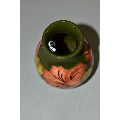 382 - A MOORCROFT POTTERY BALUSTER VASE DECORATED WITH CORAL HIBISCUS ON A GREEN GROUND, impressed marks t... 