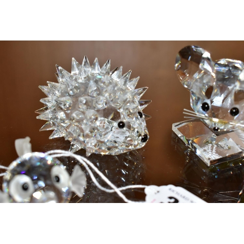 383 - THREE SWAROVSKI CRYSTAL ANIMALS AND A PUFFER FISH, the animals comprising a hedgehog, length 7cm, a ... 