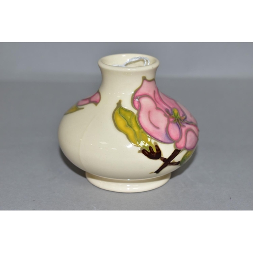 385 - A MOORCROFT POTTERY SQUAT BALUSTER VASE DECORATED WITH PINK MAGNOLIA ON A CREAM GROUND, bears gilt f... 