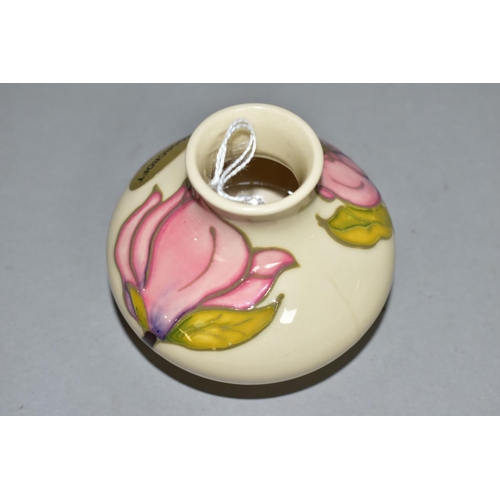 385 - A MOORCROFT POTTERY SQUAT BALUSTER VASE DECORATED WITH PINK MAGNOLIA ON A CREAM GROUND, bears gilt f... 