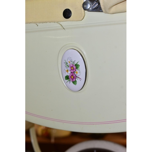 417 - TWO SILVERCROSS DOLL'S PRAMS, one lemon with pink detail and flowered decal with a matching storage ... 