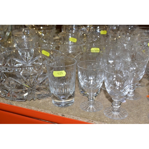 421 - A QUANTITY OF CUT CRYSTAL AND COLOURED GLASSWARE, comprising three large fruit bowls (one has nibble... 