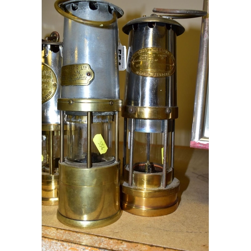 554 - THREE BRASS AND IRON MINER'S LAMPS, The Protector Lamp & Lighting Co. Ltd No. Type 1A lamp, a J.H Na... 