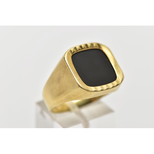 1 - AN ONYX SIGNET RING, the square shape onyx panel, within a part textured and polished surround, to t... 