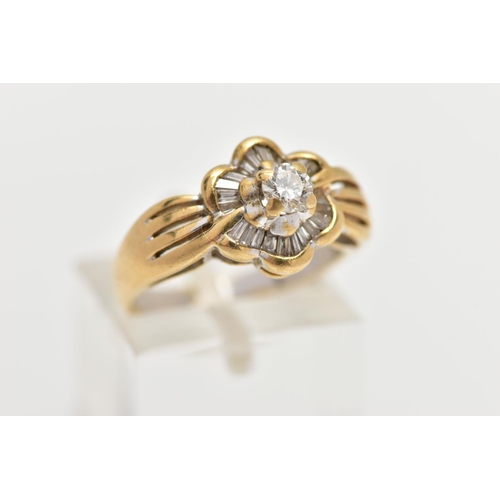 21 - A MODERN YELLOW METAL DIAMOND CLUSTER RING, set with a principal round brilliant cut diamond, within... 