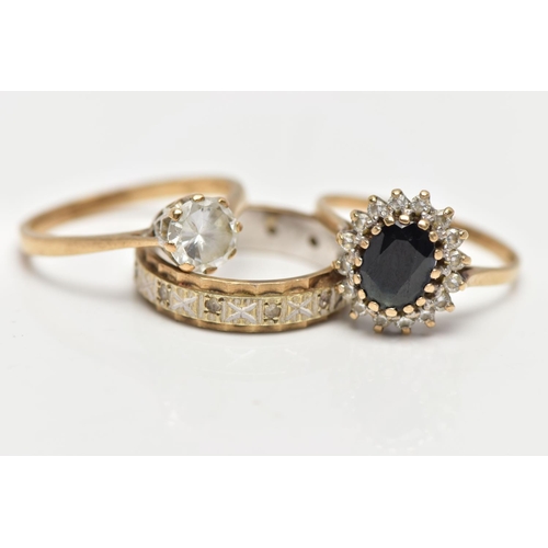 6 - TWO 9CT GOLD RINGS AND A YELLOW AND WHITE METAL RING, the first an oval cut sapphire set with a clus... 