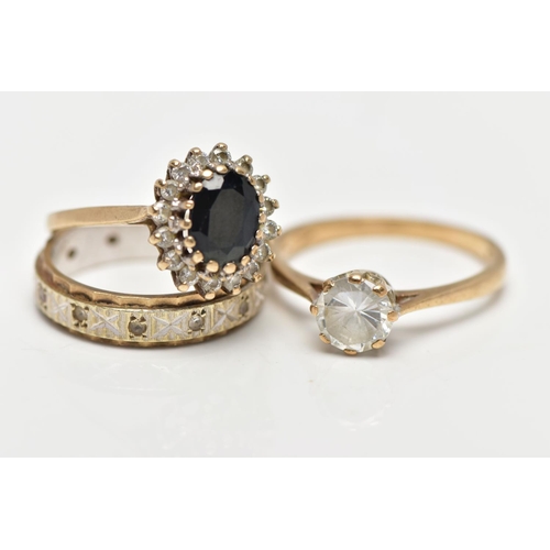 6 - TWO 9CT GOLD RINGS AND A YELLOW AND WHITE METAL RING, the first an oval cut sapphire set with a clus... 