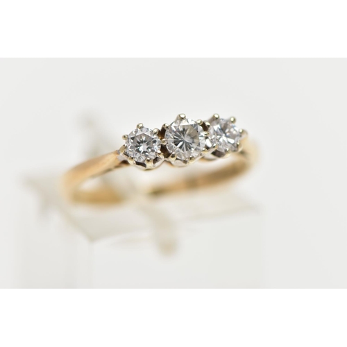 62 - A 9CT YELLOW GOLD THREE STONE DIAMOND RING, designed with three claw set, round brilliant cut diamon... 