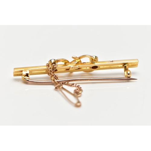 63 - A YELLOW METAL DIAMOND SET BAR BROOCH, double polished bar with a central twist design flanked with ... 