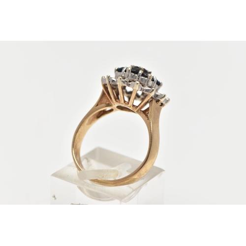 74 - A 9CT GOLD SAPPHIRE AND DIAMOND CLUSTER RING, raised circular cluster, centering on a single cut dia... 