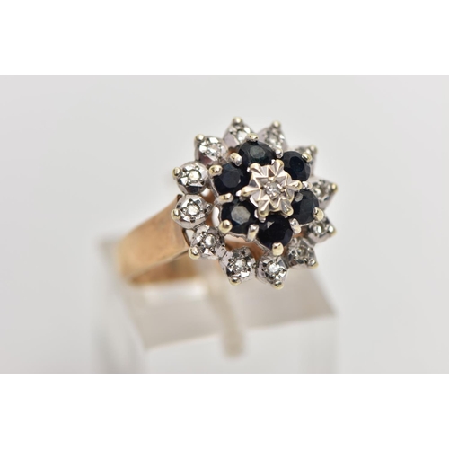 74 - A 9CT GOLD SAPPHIRE AND DIAMOND CLUSTER RING, raised circular cluster, centering on a single cut dia... 