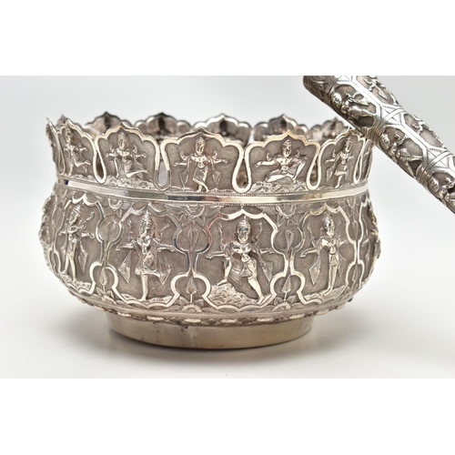 92 - AN INDIAN WHITE METAL BOWL, with multi-point cut rim,  repousse decorated throughout with deities an... 