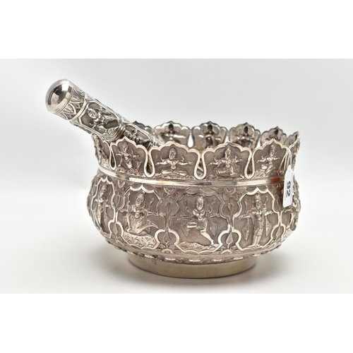 92 - AN INDIAN WHITE METAL BOWL, with multi-point cut rim,  repousse decorated throughout with deities an... 