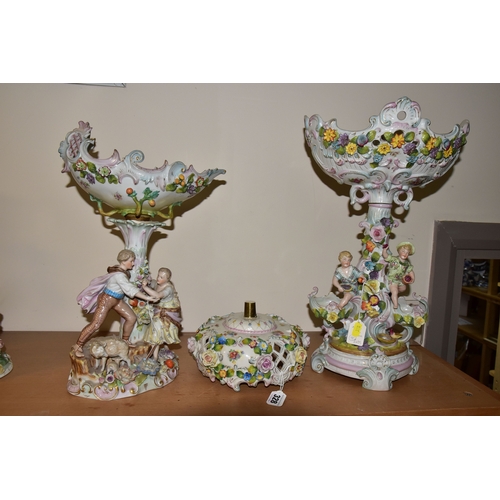 328 - TWO PORCELAIN FIGURAL CENTREPIECES, each pierced decorated bowl surmounting a central column with fi... 