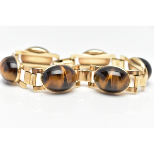 103 - A YELLOW METAL AND TIGERS EYE BRACELET, comprised of six links each set with oval tigers eye cabocho... 