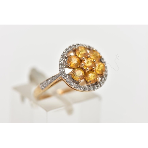 110 - A 9CT GOLD YELLOW SAPPHIRE AND DIAMOND CLUSTER RING, the openwork circular cut yellow sapphire clust... 