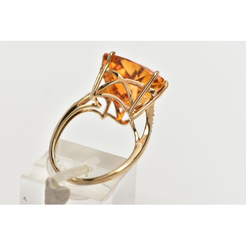 111 - A 9CT GOLD CITRINE AND DIAMOND DRESS RING, the raised triangular cut citrine, with single cut diamon... 