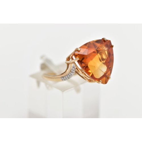 111 - A 9CT GOLD CITRINE AND DIAMOND DRESS RING, the raised triangular cut citrine, with single cut diamon... 