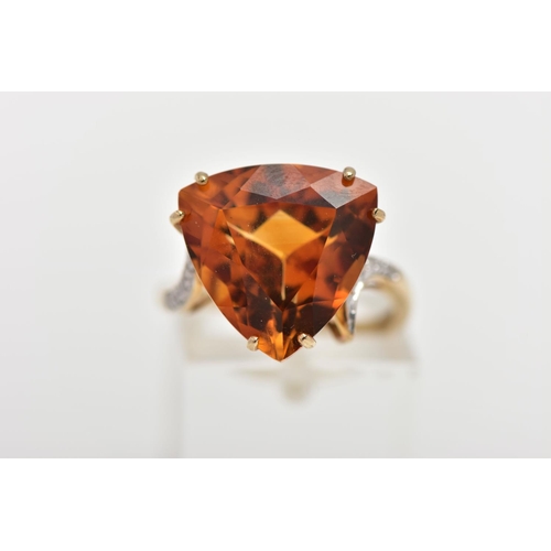 111 - A 9CT GOLD CITRINE AND DIAMOND DRESS RING, the raised triangular cut citrine, with single cut diamon... 