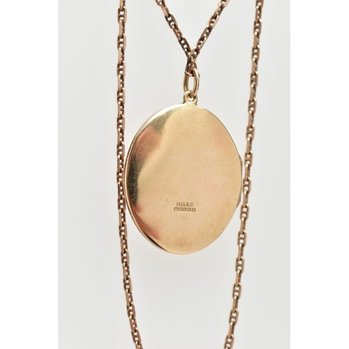 127 - A 9CT YELLOW GOLD LOCKET AND CHAIN, the oval shape locket with foliate engraved scene, opening to re... 