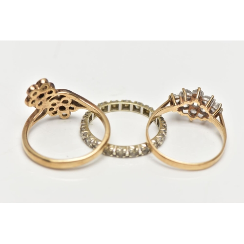 129 - THREE YELLOW METAL DRESS RINGS, to include a 9ct gold colourless paste double cluster ring, AF one s... 