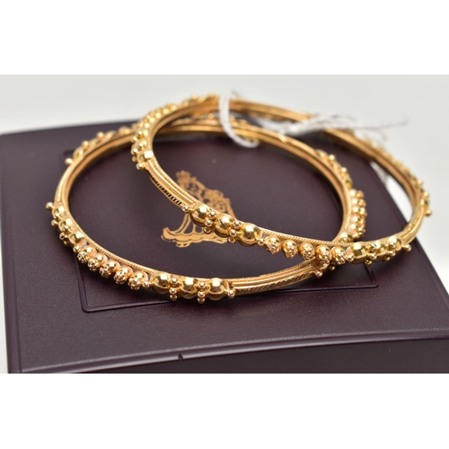 138 - TWO ASIAN GOLD BANGLES, each designed with spherical bead accents, engraved and rope twist detail, i... 