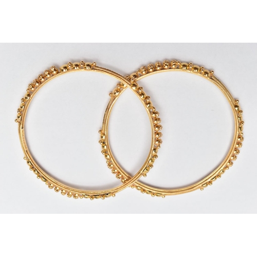 138 - TWO ASIAN GOLD BANGLES, each designed with spherical bead accents, engraved and rope twist detail, i... 