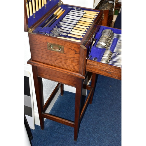 171 - A WOODEN FREE STANDING INCOMPLETE CANTEEN, comprising cutlery with names to include 'Robert F Mosley... 