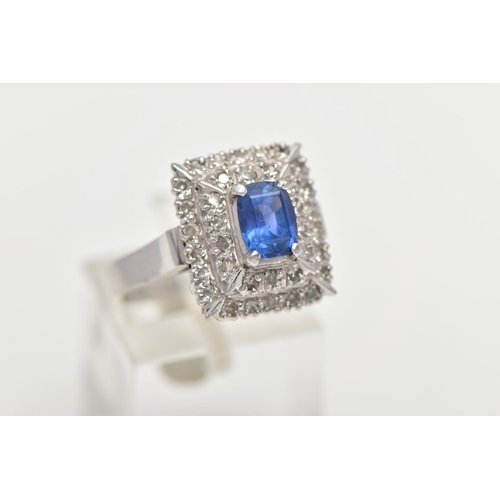 97 - A SAPPHIRE AND DIAMOND CLUSTER RING, set with a rectangular cushion shape sapphire, measuring approx... 