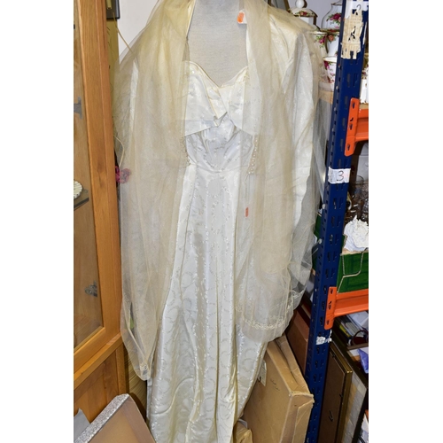 316 - TWO VINTAGE WEDDING DRESSES AND A VEIL, comprising an early 1950's style gown made by Vivinette, in ... 