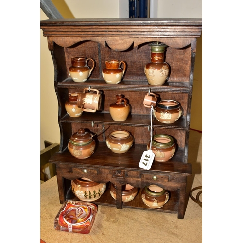 317 - A MINIATURE WOODEN DRESSER by D.E Arthur displaying an assortment of miniature Doulton Lambeth Harve... 