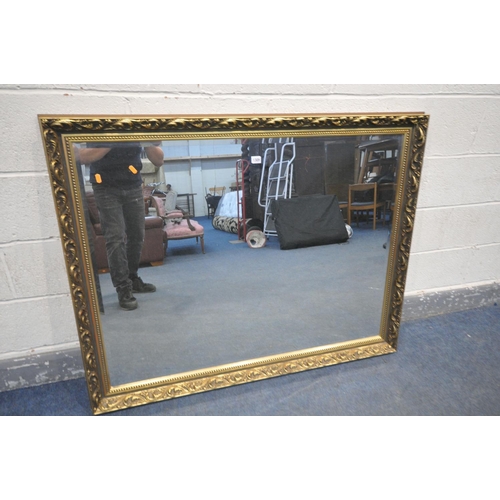 1305 - A FOLIATE GILT FRAMED BEVELLED EDGE WALL MIRROR, 131cm x 103cm