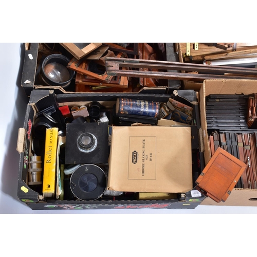 22 - FIVE TRAYS CONTAINING VINTAGE FIELD CAMERA AND TRIPOD PARTS including plate carriers, a lens carriag... 