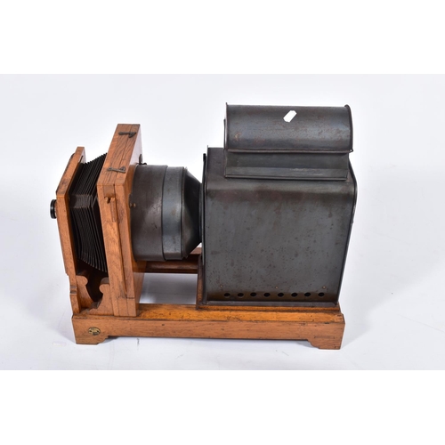 36 - A 'KING ENLARGER' MAGIC LANTERN with an oak frame and tinplate body along with two covers