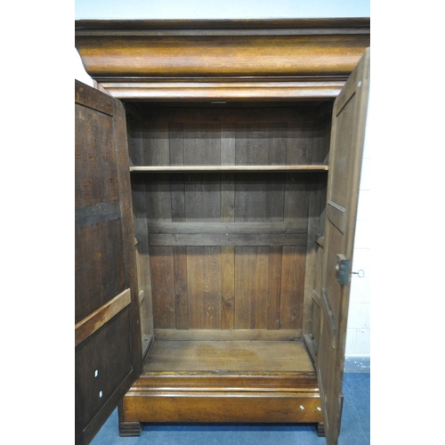 1190 - AN EARLY 20TH CENTURY OAK FRENCH ARMOIRE, the double paneled doors over a single long drawer, on Art... 