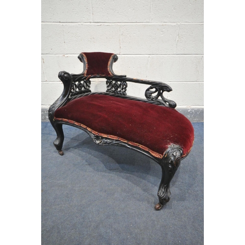 1199 - A 19TH CENTURY EBONISED CARVED WOOD SERPENTINE CHAISE LONGUE, of small proportions, having a scrolle... 