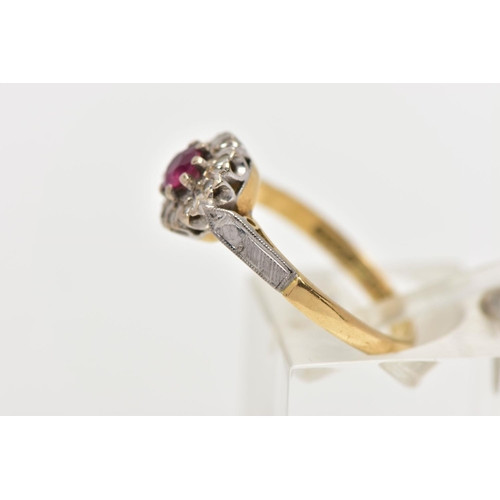 11 - A MID 20TH CENTURY 18CT GOLD RUBY AND DIAMOND CLUSTER RING, set with a circular cut ruby, measuring ... 